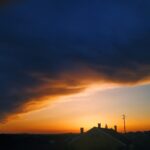 Heavy clouds over dramatic sunset with wide skyline